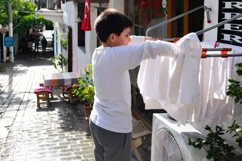 Young Boy Drying Clothes Stock-Fotos