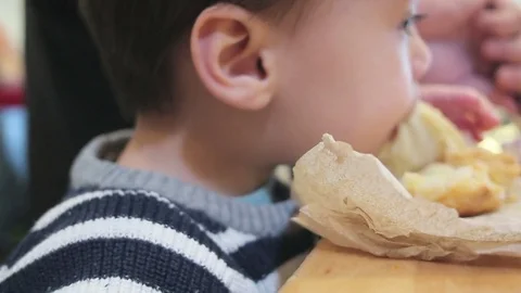 Young boy eating at a bakery Stock Footage 83663645