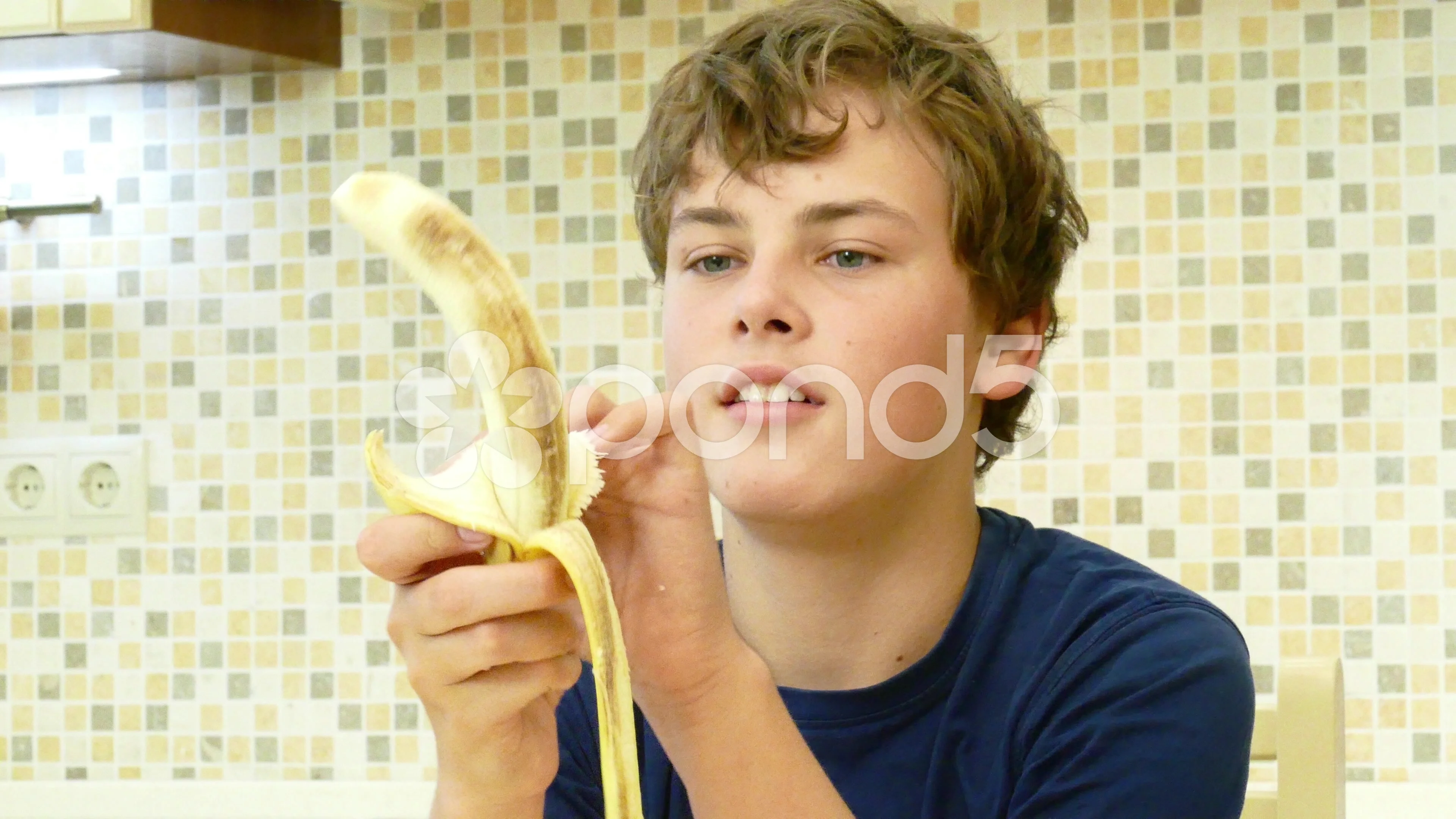 child eating banana