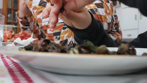 Young boy eating barnacles for lunch Video stock 237527676