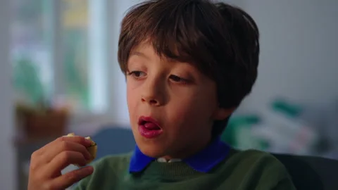 Young boy eats a fresh apple while seated at dining table at home, promotin.. Stock Footage 343662047