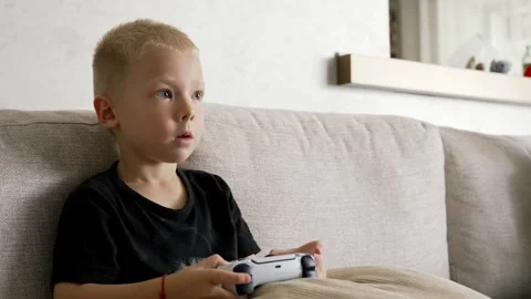 Young Boy Engrossed in Gaming on a Sofa Stock Video Pond5