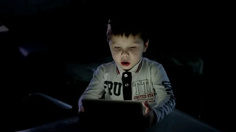 Young Boy Engrossed in Playing Games on His Digital Tablet at Home Stock Footage 73669635