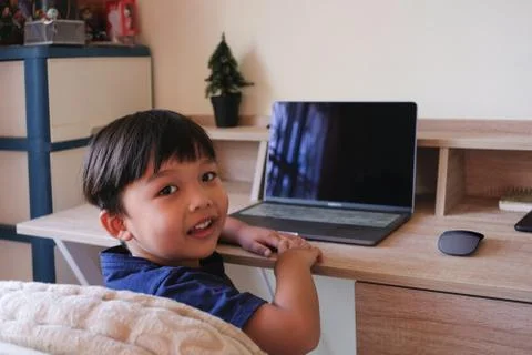 Young boy enjoy study lessons and do homework on laptop at home Fotos Stock