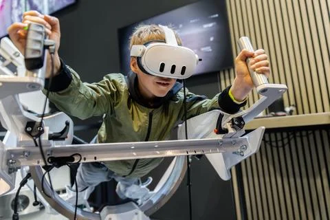 Young boy experience immersive virtual reality flight simulator game educatio Stock Photos