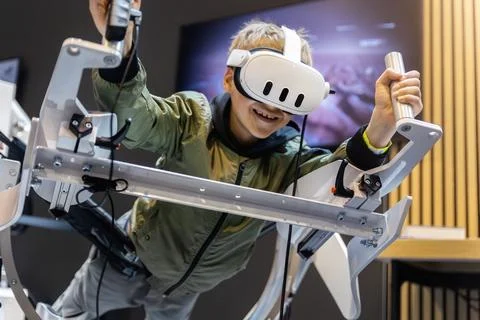 Young boy experience immersive virtual reality flight simulator game educatio Stock Photos