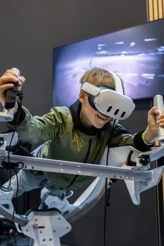 Young boy experience immersive virtual reality flight simulator game educatio Stock Photos