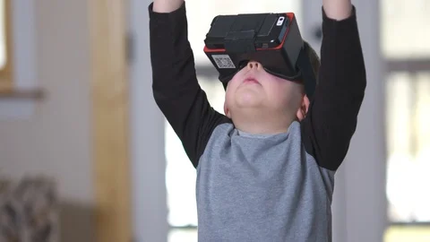 Young boy experiences virtual reality for the first time Stock Footage 85490524