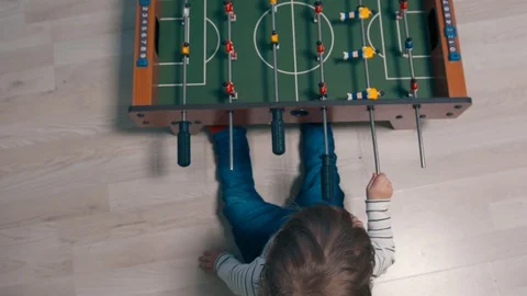 Young boy exploring table football Stock Footage 106064239