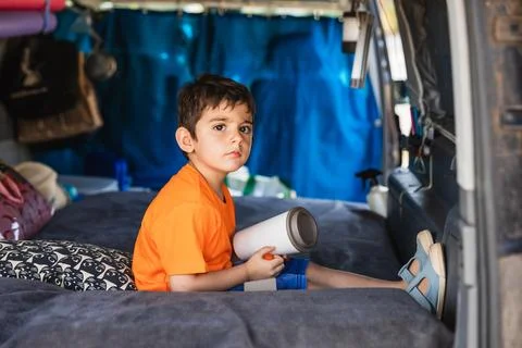 Young boy exploring van life camper interior Fotos Stock