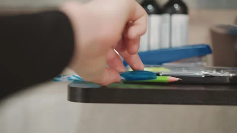 Young boy extends hand to grab colored pencil. Grandson carefully approaches Stock Footage 337823044
