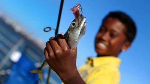 Young Boy With Fish Фото