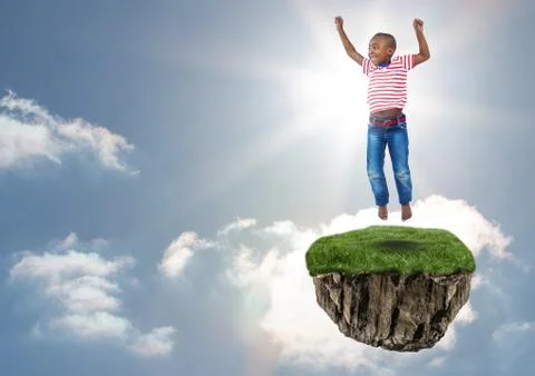 Young boy on floating rock platform  in sky jumping Stock Photos