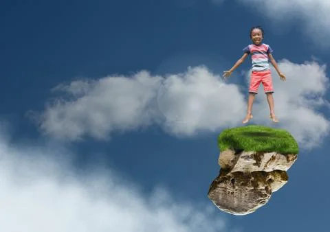 Young boy on floating rock platform  in sky jumping Stock Photos