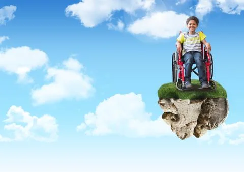 Young boy on floating rock platform  in sky in wheelchair Stock Photos