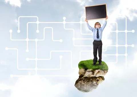 Young boy on floating rock platform  in sky holding blackboard with connectors Stock Photos