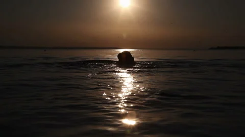 A young boy floats at sunset Stock Footage 66350466