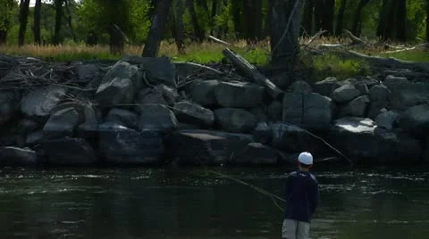 Young Boy fly casting into Yellowstone River Video stock 14493225