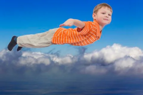 Young boy flying with cloud sky in background Stock Photos