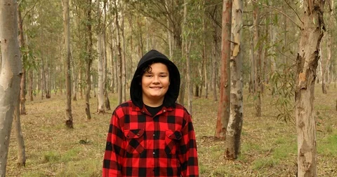 Young boy on forest hike looking at the camera and smiling Stock Footage 121008789