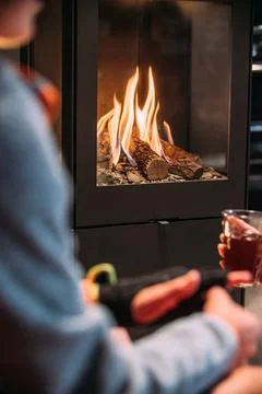 Young boy in front of the fireplace. Stock Photos
