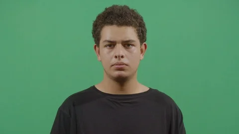 Young boy frowning the eyebrows like receiving a notice that was not expected or Stock Footage 115337343