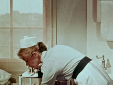 Young boy getting put into a hospital bed, Scotland, United kingdom, uk, 1948 Stock Footage 134036080