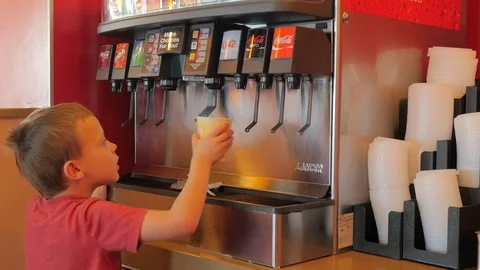 Young boy getting soda pop from a fountain machine Video stock 70035551