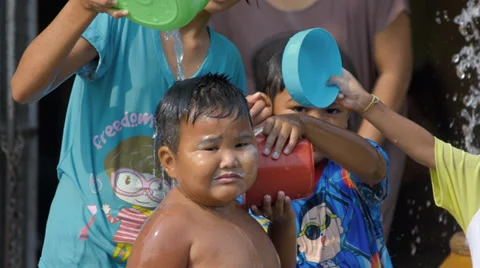 Young Boy Getting Splashed By His Friends in a Songkran Festival Water Fight Stock Footage 37165926