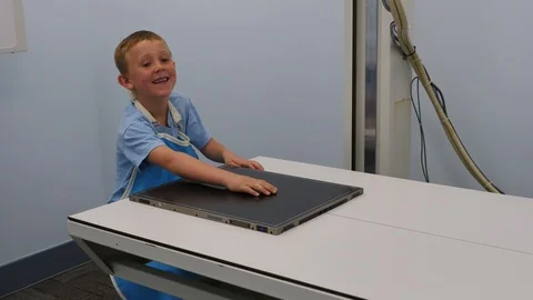 Young boy getting an x ray on a broken hand Stock Footage 118570907