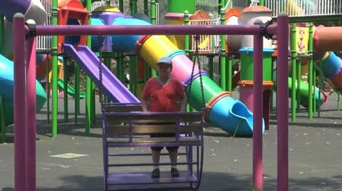 Young boy is given the swing in the park Vídeos de archivo 11888551