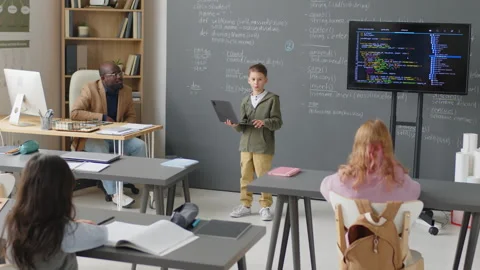 Young Boy Giving Presentation on Programming in front of Class Stock Footage 244698206