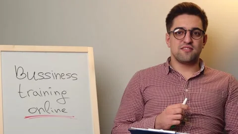 Young boy with glasses is having online business training lessons speaking at Stock Footage 146010432