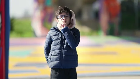 Young boy with glasses making a shushing gesture 库存影片 327856015
