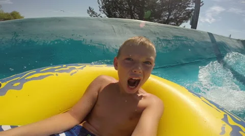 Young boy going down a waterslide at waterpark, POV video Stock Footage 55526889