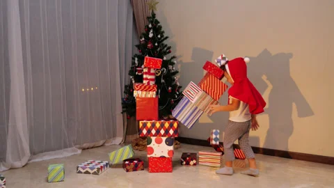 Young boy grab one box and destroy christmas gift tower Stock Footage 300370813