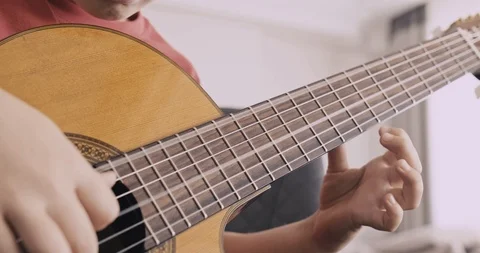 Young boy with a guitar. Boy of 8 years plays the classical guitar. The cauca Stock Footage 118059386