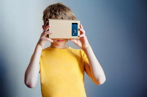 Young boy with hand holding virtual reality device Stock Photos