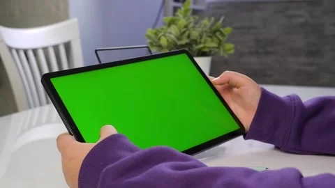 Young boy  hand touching a pad  with horizontal green screen pad. Stock Footage 167910488