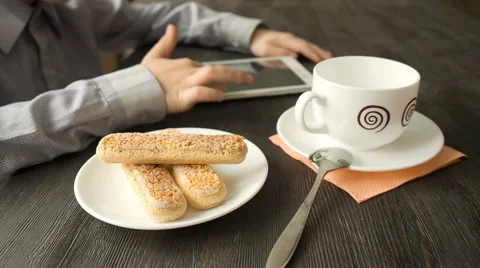 Young boy hands uses tablet PC sitting at the wood table Stock Footage 63639750
