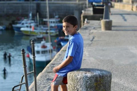 Young boy in a harbor Stock Photos