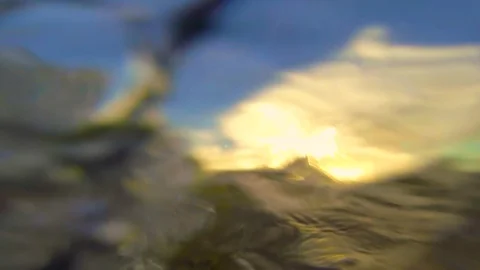 Young boy has fun playing in the ocean with a bodyboard at sunset. Vidéo 88342737