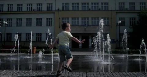 Young Boy Havin Fun Near Modern Splash Water Fountain Stock Footage 67507101
