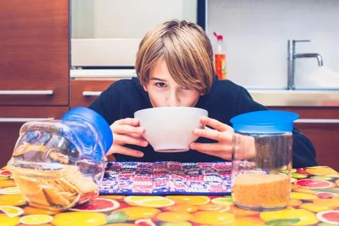 Young boy having breakfast before going to school New day of ordinary life Stock Photos