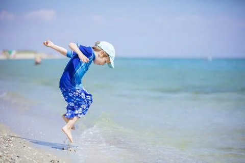 Young boy having fun on the beach Stock Photos