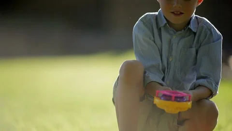 Young boy having fun blowing bubbles in a sunny back yard. Stock Footage 88341968