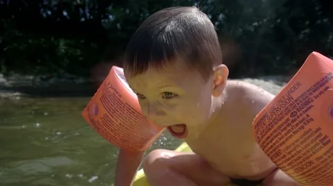 Young Boy Having Fun on Inflatable Mattress in the Mountain River Stock Footage 66561330