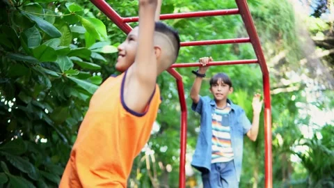 Young boy having fun on monkey bars in park Video stock 312690979