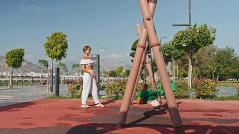 Young boy having fun on the swing. His mother or babysitter his swinging him and Video stock 255071641