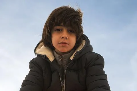 Young boy having serious expression on cold winter day Stock Photos